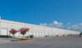Photo of a large white warehouse.