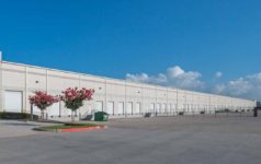 Photo of a large white warehouse.