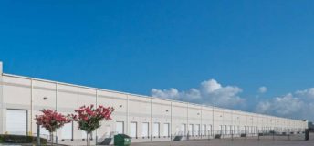 Photo of a large white warehouse.