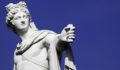 A statue of Greek god Apollo against a blue background