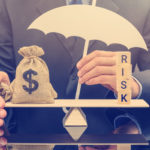 Businessman holding a white umbrella, protecting a dollar bag on basic balance scale, and defending money from being cheat or fraud.