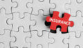 Photo of a puzzle with the final piece being placed labeled insurance.