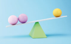 Graphic of two purple spheres and one yellow sphere balancing on top of a green triangle