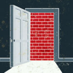 An open door is blocked by a brick wall