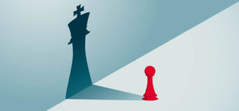 A red pawn chess piece with a shadow of a king chess piece