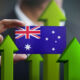 Nation Growth Concept, Green Up Arrows - Businessman Holding Card of Australia Flag