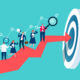 Businesspeople working on top of a red arrow as it approaches its goal