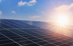 The challenge of refinancing ageing renewables Solar panels with sunset and blue sky background. Clean power energy concept