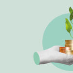 A severed hand holds several stacks of coins from which a green shoot sprouts