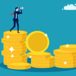 Image of a business person standing on a stack of coins.