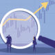 Two businessmen using a magnifying glass to observe market trends.