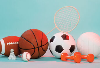 Sports and media may be a game changer A pile of various sports equipment including a basketball, a shuttlecock and some weights