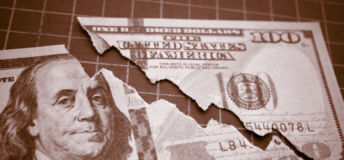 Image of a $100 bill torn in a decreasing line.
