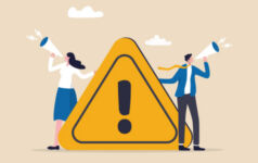 Figures with loud hailers issuing warnings holding ! sign