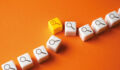 White cubes with a magnifying glass icon are lined up, with one yellow one bumped slightly out of line