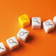 White cubes with a magnifying glass icon are lined up, with one yellow one bumped slightly out of line