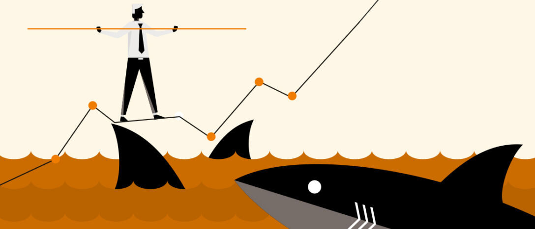 A man walks on a tightrope above shark infested waters