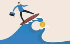 A suited man wholding a briefcase surfs a wave with a coin in it