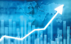 A glowing arrow points upwards in front of a bar chart, signalling growth