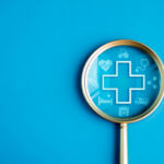 Image of a magnifying glass with medical symbols inside.