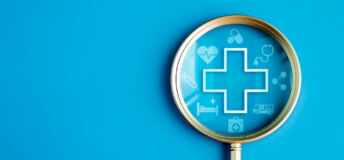 Image of a magnifying glass with medical symbols inside.