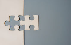 Credit manager Serone launches buyout secondaries strategy Two puzzle pieces connecting, one white and one grey, on a contrasting background