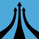 Three black arrows heading up on a blue background