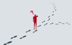 A red silhouette of a man scratching his head beneath a red question mark, standing where a path of footprints splits into two directions.